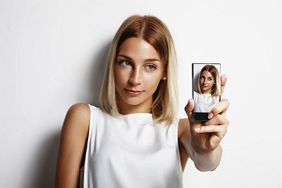 Woman making selfie with mobile phone --- Image by © pinkypills/Corbis